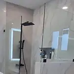 Frameless Glass Fixed Shower Panels with Matte Black Hardware