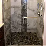 Frameless Glass Shower with Brushed Nickel Hardware and outside Towel Bar