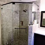 Frameless Glass Shower with Oil-Rubbed Bronze Hardware and Header