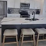 Forevermark: Ice White Shaker Cabinets with Greystone Shaker Island